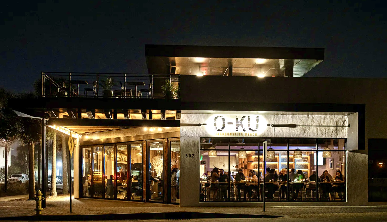 Exterior view of the O KU restaurant in the night